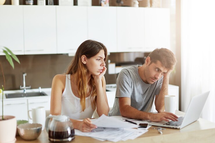 young-couple-checking-their-family-budget_273609-12813